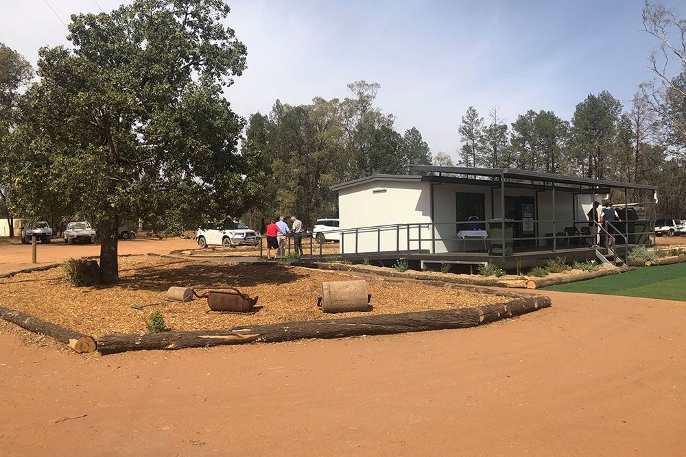 Portable House Featuring a Steel Staircase and a Large Tree in Its Yard — OSM Transportables In Dubbo, NSW