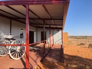 Portable House With Parked 2 Wheeled Carriage in the Porch — OSM Transportables In Dubbo, NSW