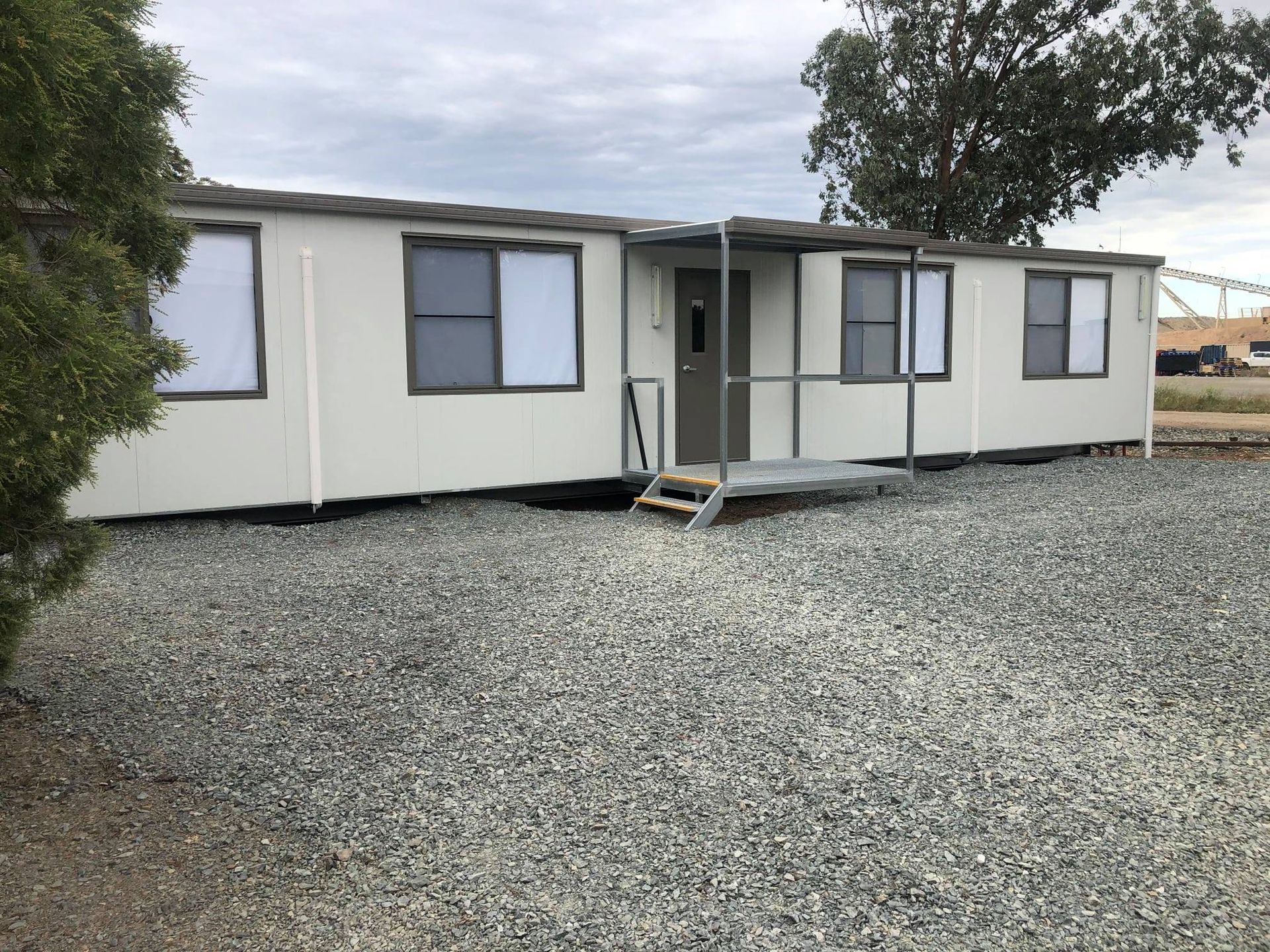 A Modular, Off-white Building With Dark-framed Windows — OSM Transportables In Dubbo, NSW