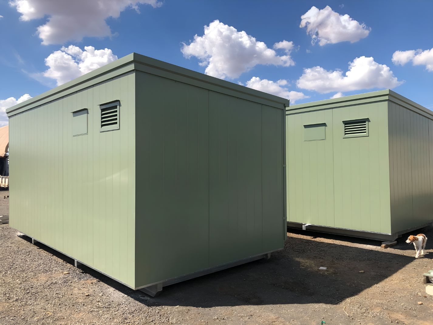 Two Green Buildings Are Sitting Next to Each Other in a Dirt Field — OSM Transportables In Dunedoo, NSW