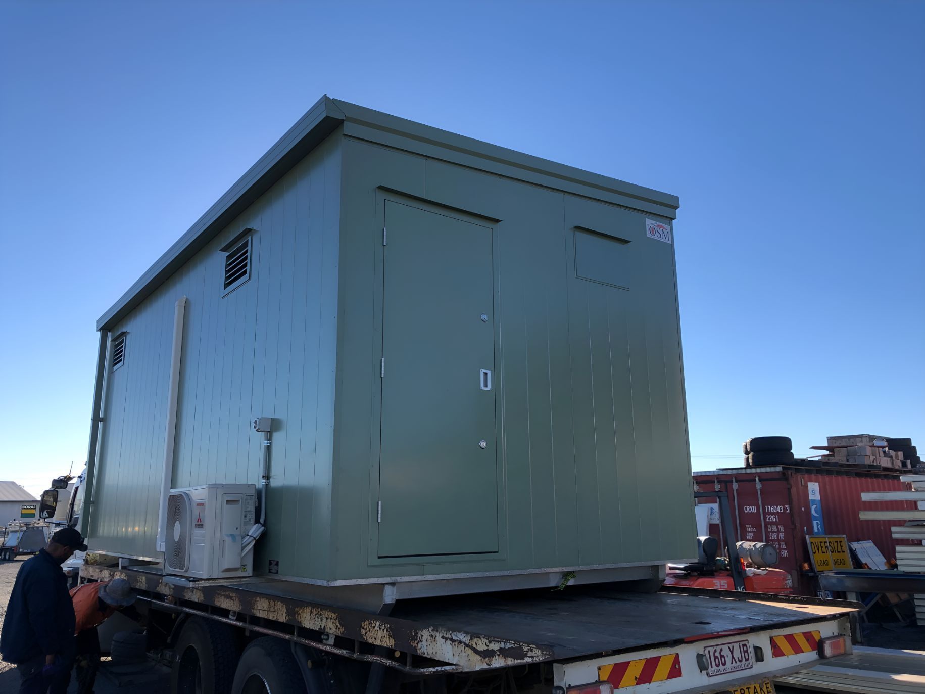 A Green Container is Sitting on Top of a Flatbed Truck — OSM Transportables In Dunedoo, NSW