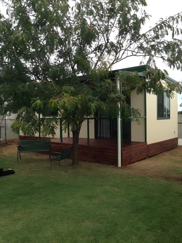 A Small House With a Porch and a Bench in Front of It — OSM Transportables In Dunedoo, NSW