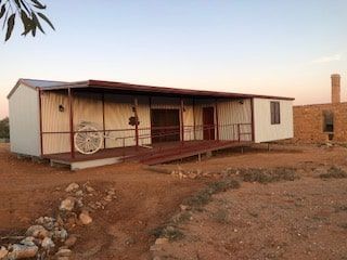Wide View Shot of Portable House With Parked 2 Wheeled Carriage in the Porch — OSM Transportables In Dubbo, NSW