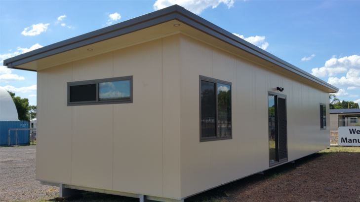 Side View of a White House Featuring Glass Windows, Showcasing Its Elegant Design — OSM Transportables In Dubbo, NSW