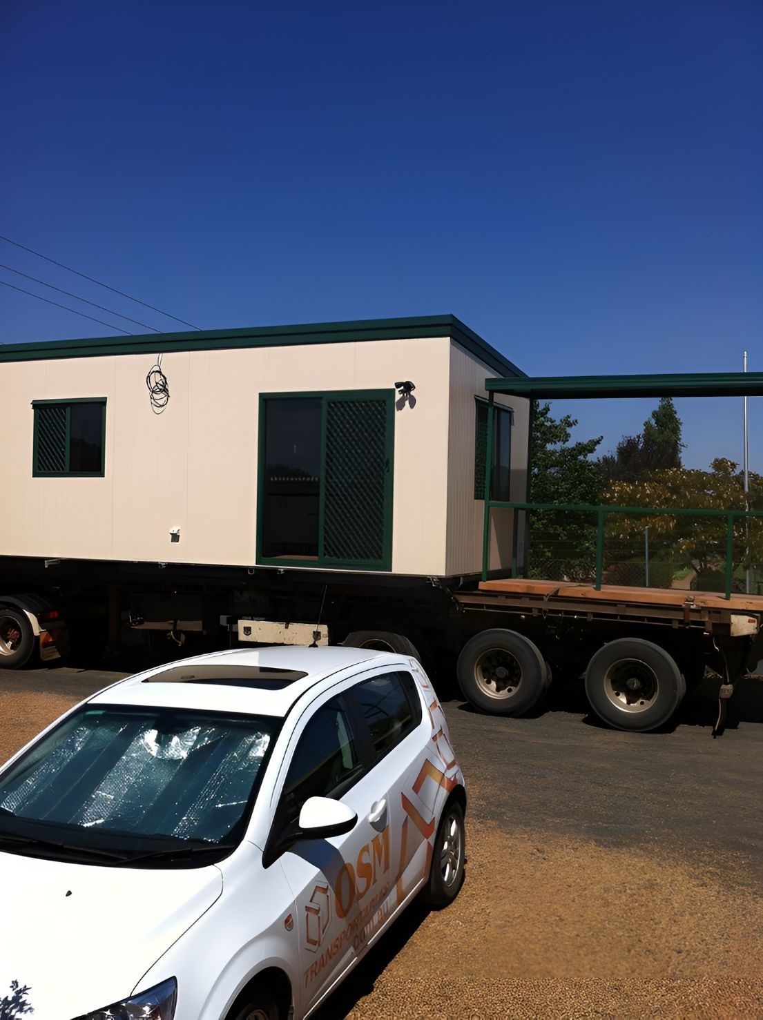 A White Car is Parked in Front of a Trailer — OSM Transportables In Coonabarabran, NSW