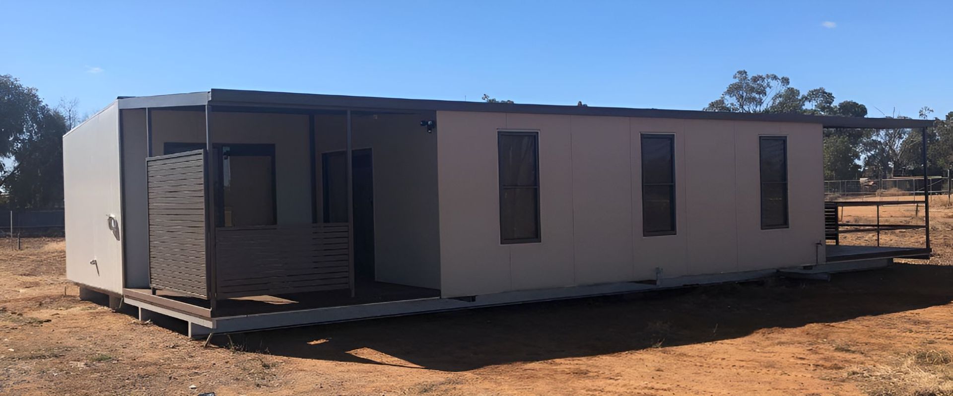 A Small House is Sitting in the Middle of a Dirt Field — OSM Transportables In Coonabarabran, NSW