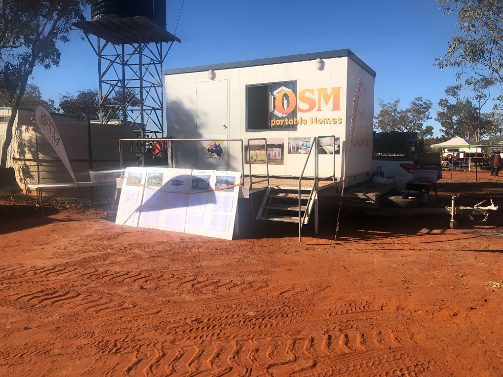 A White Trailer With the Word Dsm on It is Parked in a Dirt Field — OSM Transportables In Nyngan, NSW