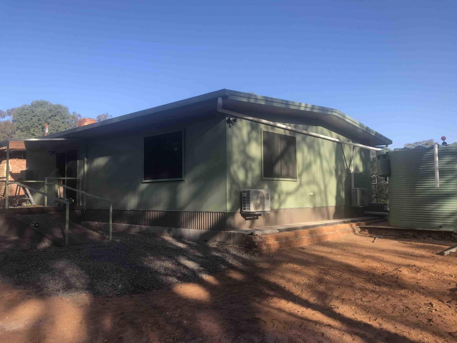 Transportable House Painted in Dark Green, Offering Versatile and Stylish Accommodation — OSM Transportables In Dubbo, NSW