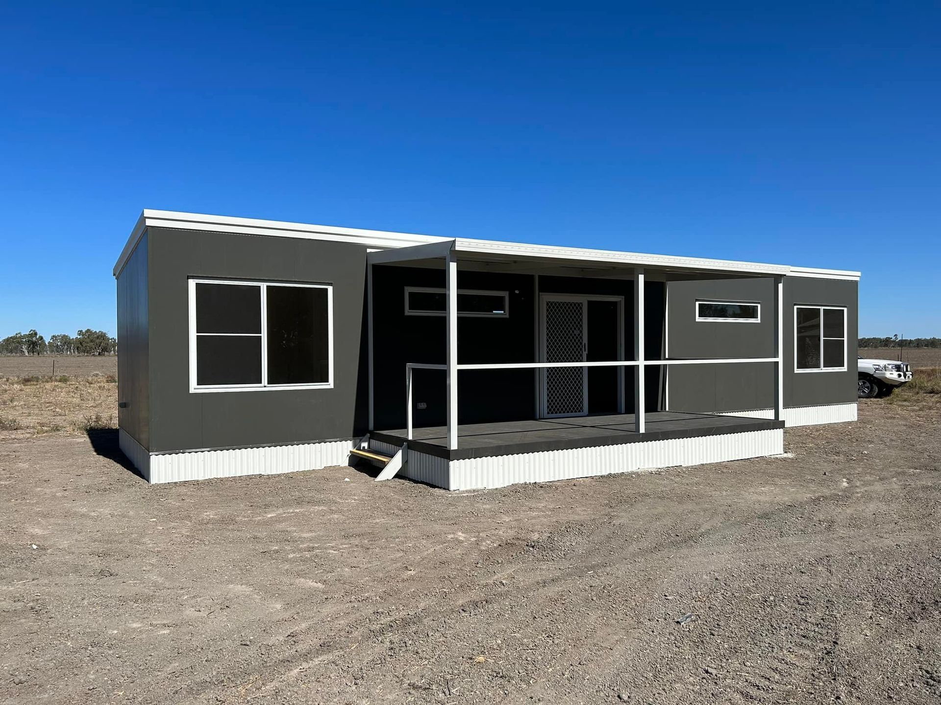 A Modern, Dark Grey Modular Cabin With a Front Porch — OSM Transportables In Dubbo, NSW