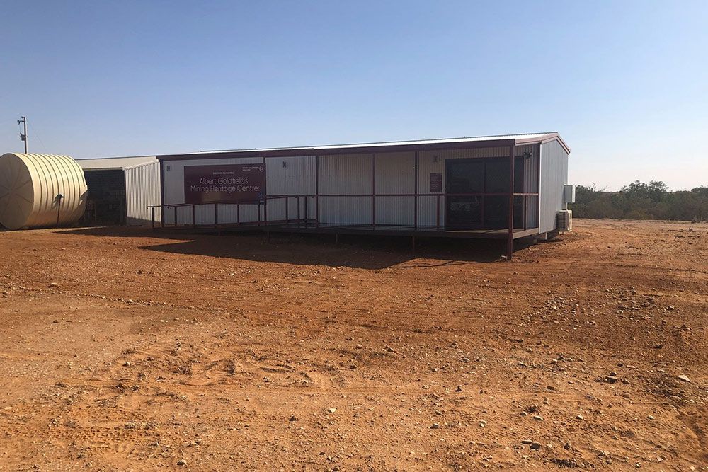 Commercial Building Featuring a Sliding Glass Door and a Sturdy Steel Fence — OSM Transportables In Dubbo, NSW