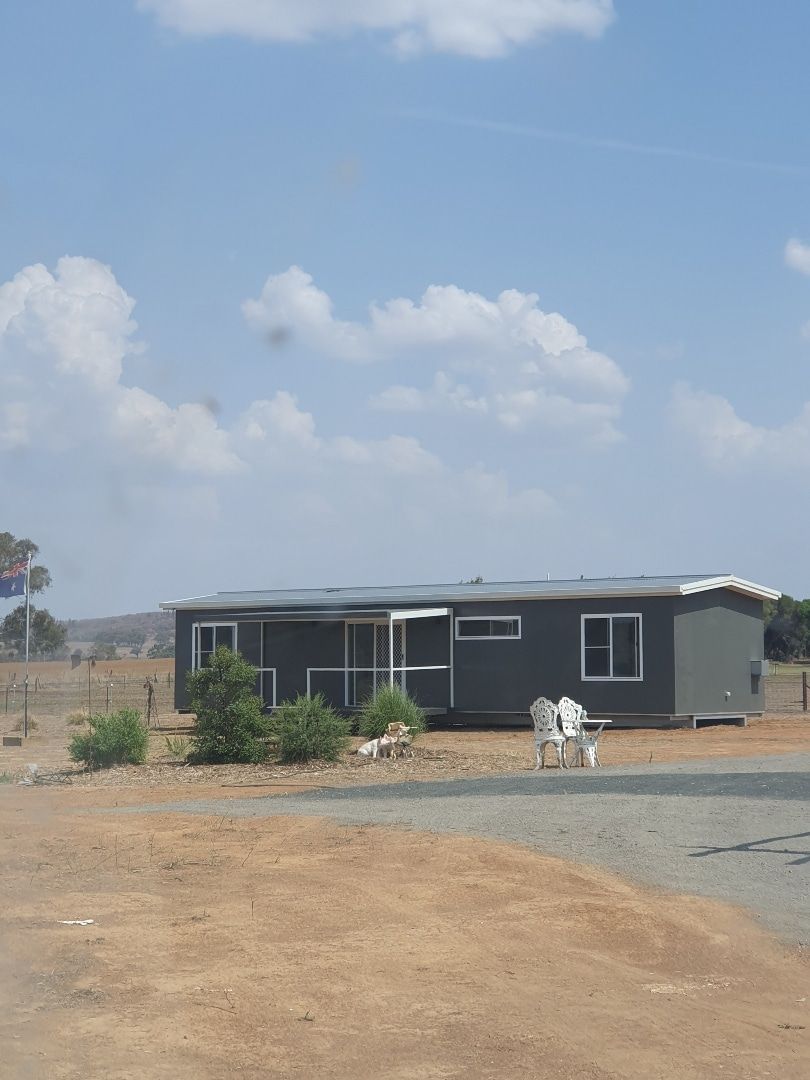 Panoramic View of a Dark Grey House With Chairs Positioned Outside — OSM Transportables In Dubbo, NSW