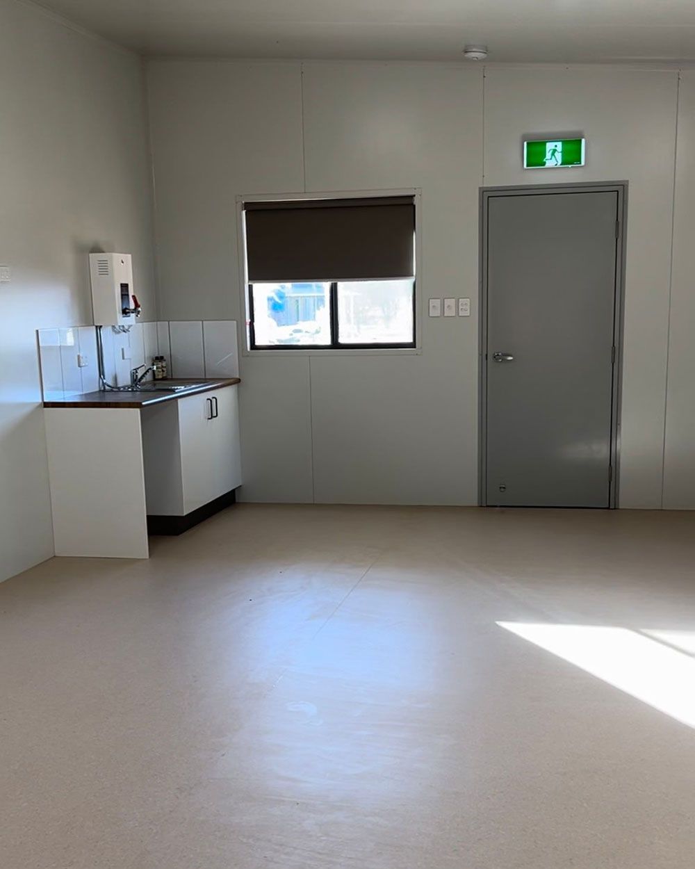 A Bright, Sparse Room Featuring a Sink Counter on the Left — OSM Transportables In Dubbo, NSW