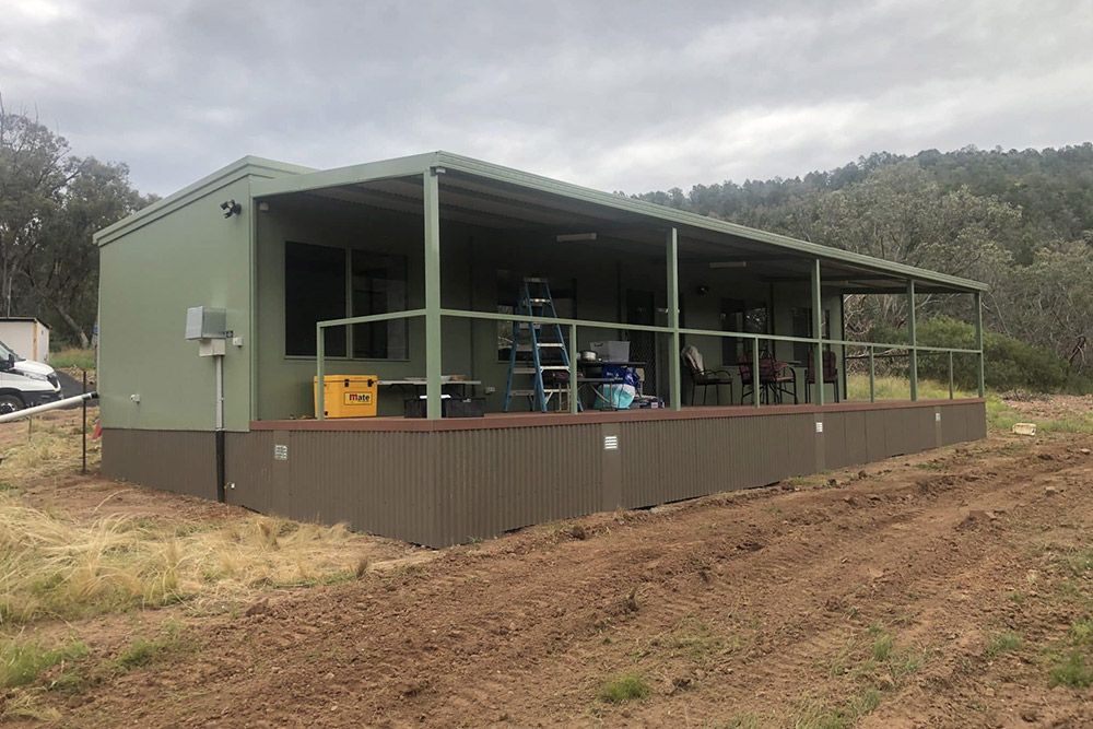 Side View of a Transportable House Showcasing a Long, Dark Brown Staircase — OSM Transportables In Dubbo, NSW