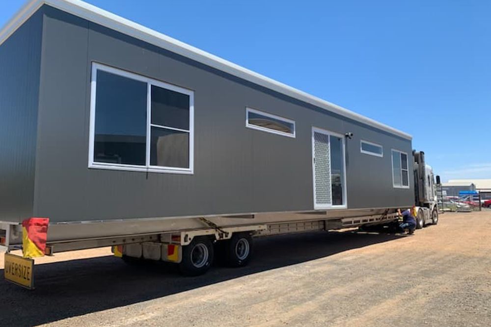 Long 1 Storey Portable House Loaded at the Back of the Truck — OSM Transportables In Dubbo, NSW