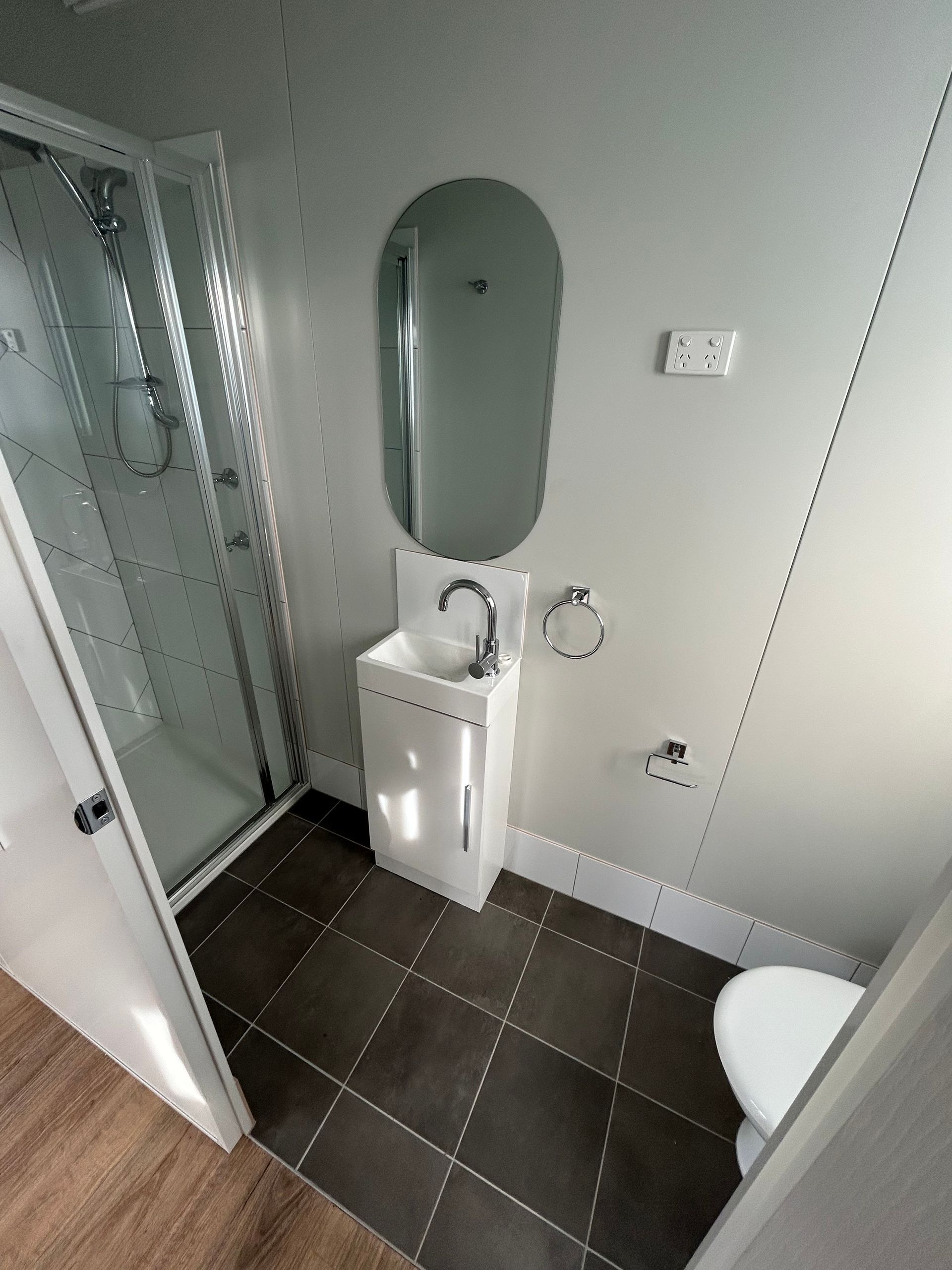 A Small Bathroom Featuring a Walk-in Glass Shower — OSM Transportables In Dubbo, NSW