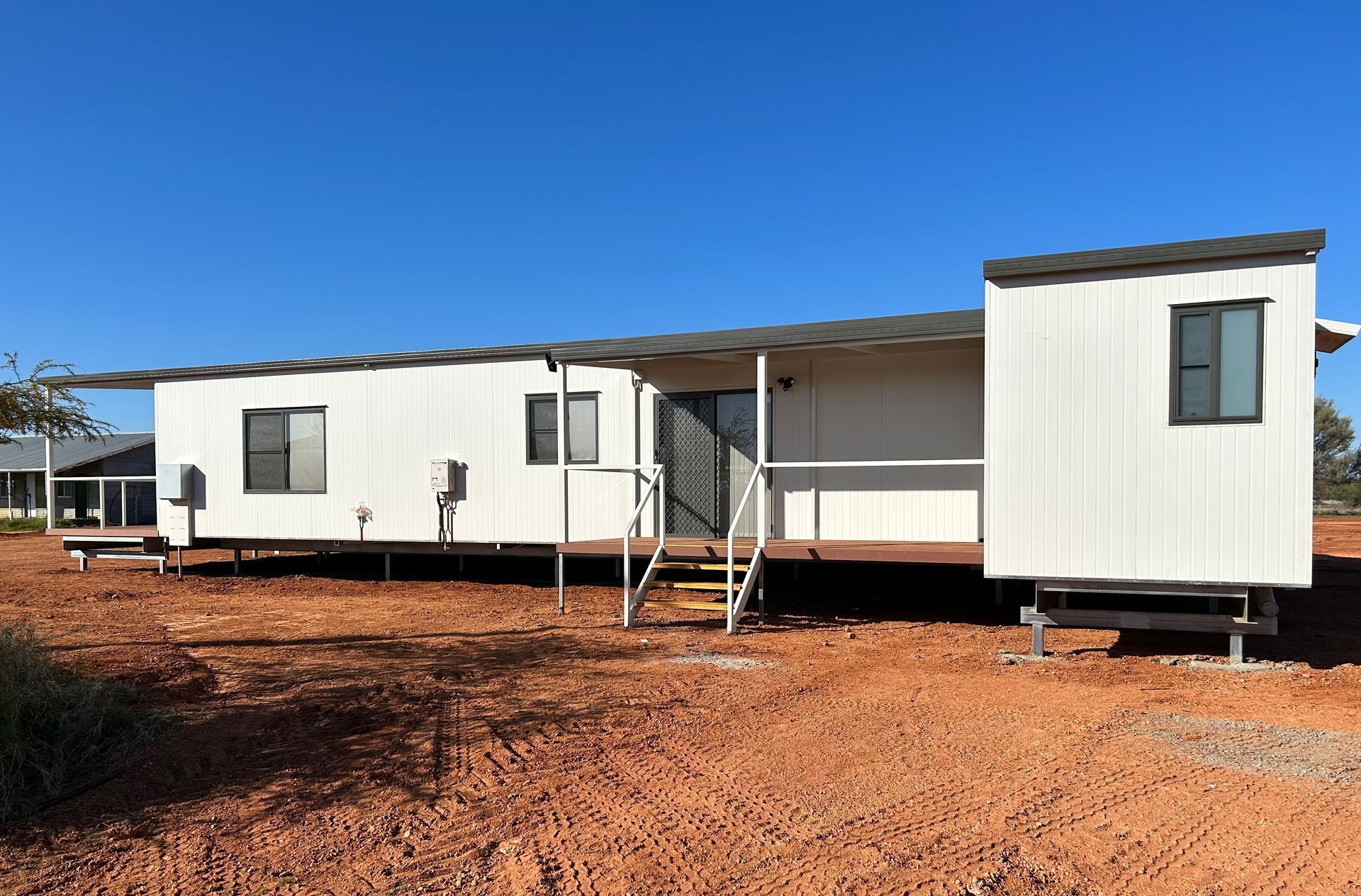 A White House is Sitting on Top of a Dirt Field — OSM Transportables In Dubbo, NSW