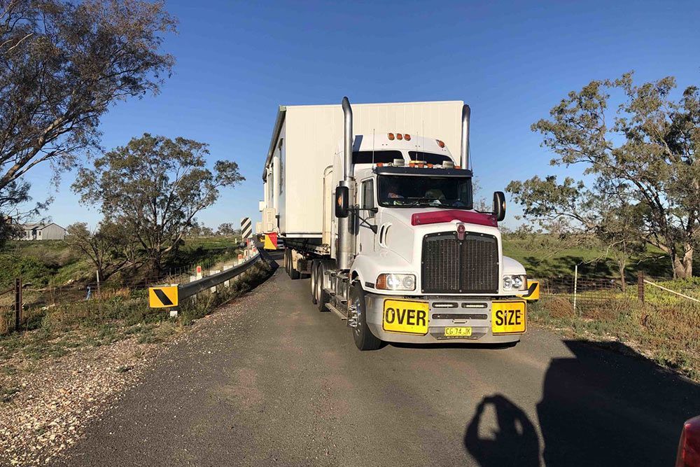 Large Truck Transporting a Portable House — OSM Transportables In Dubbo, NSW