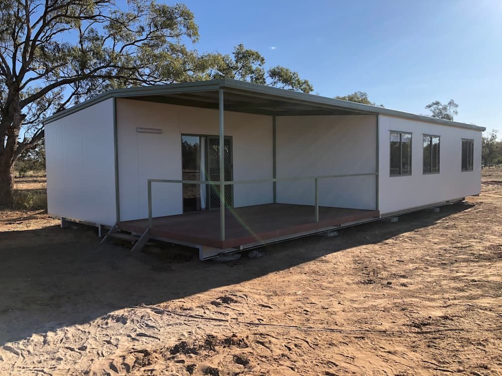 Spacious White Long Portable House Featuring Sliding Windows, Doors, and a Porch — OSM Transportables In Dubbo, NSW