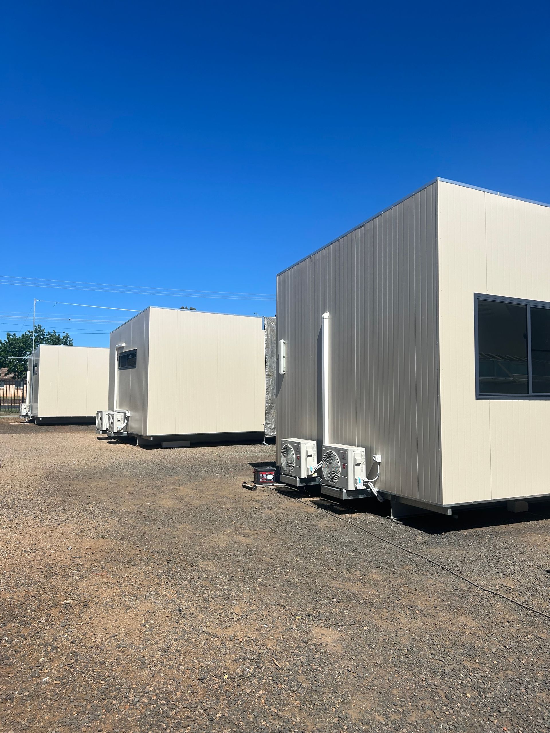 Three Beige, Rectangular Modular Buildings With Small Windows — OSM Transportables In Dubbo, NSW