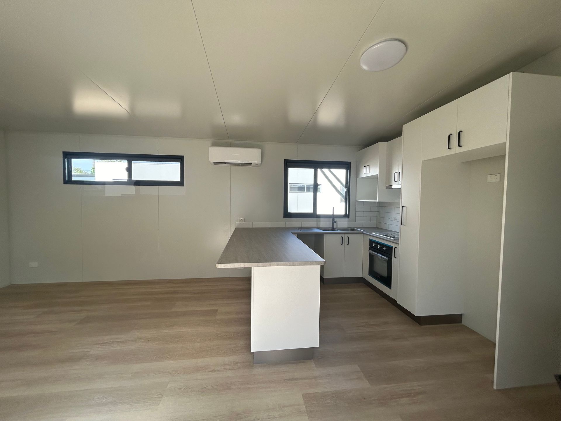 A Modern, Minimalist Kitchen With White Cabinets — OSM Transportables In Dubbo, NSW