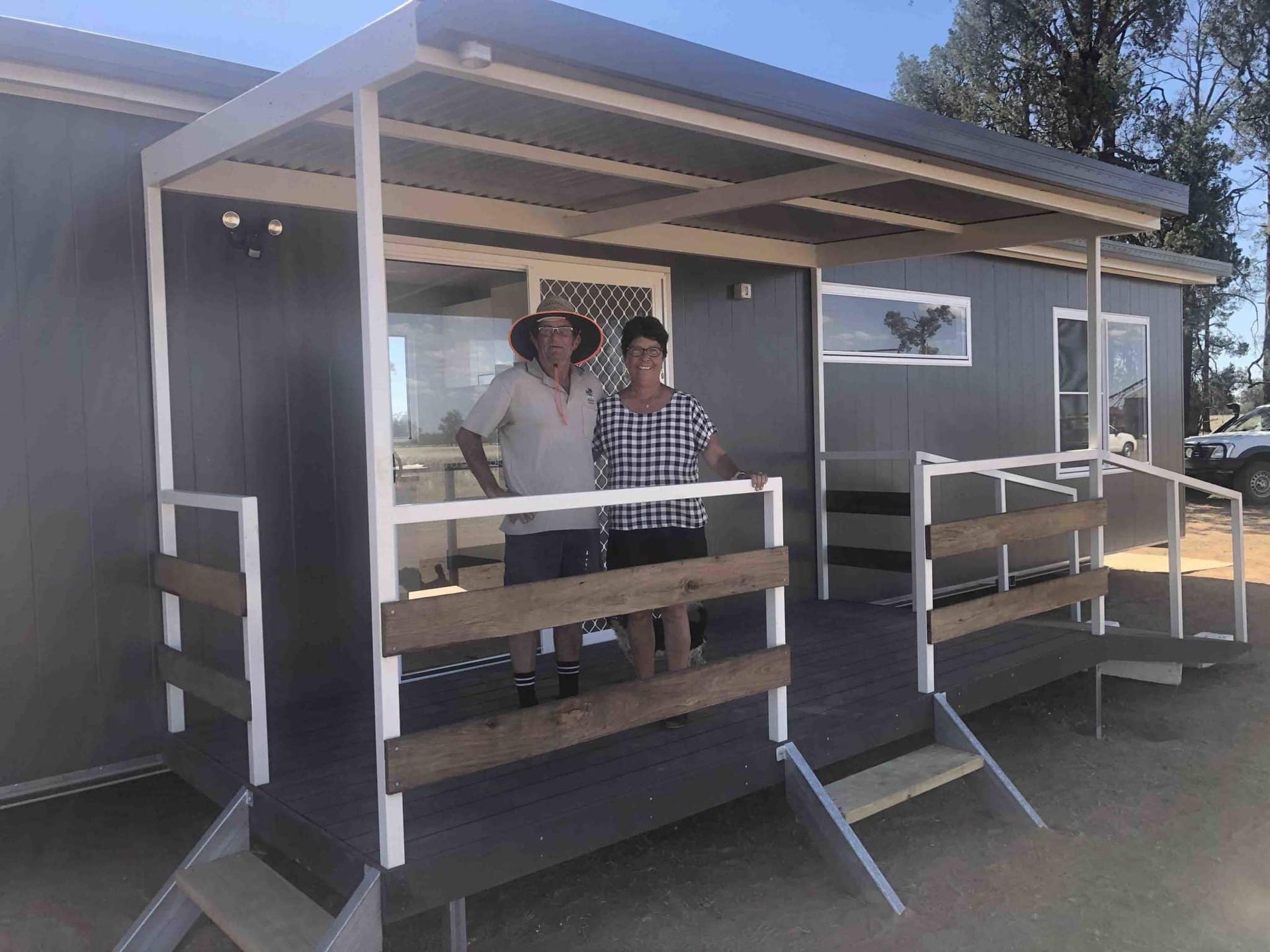 Man and Woman Standing Together on the Porch of a Transportable House — OSM Transportables In Dubbo, NSW