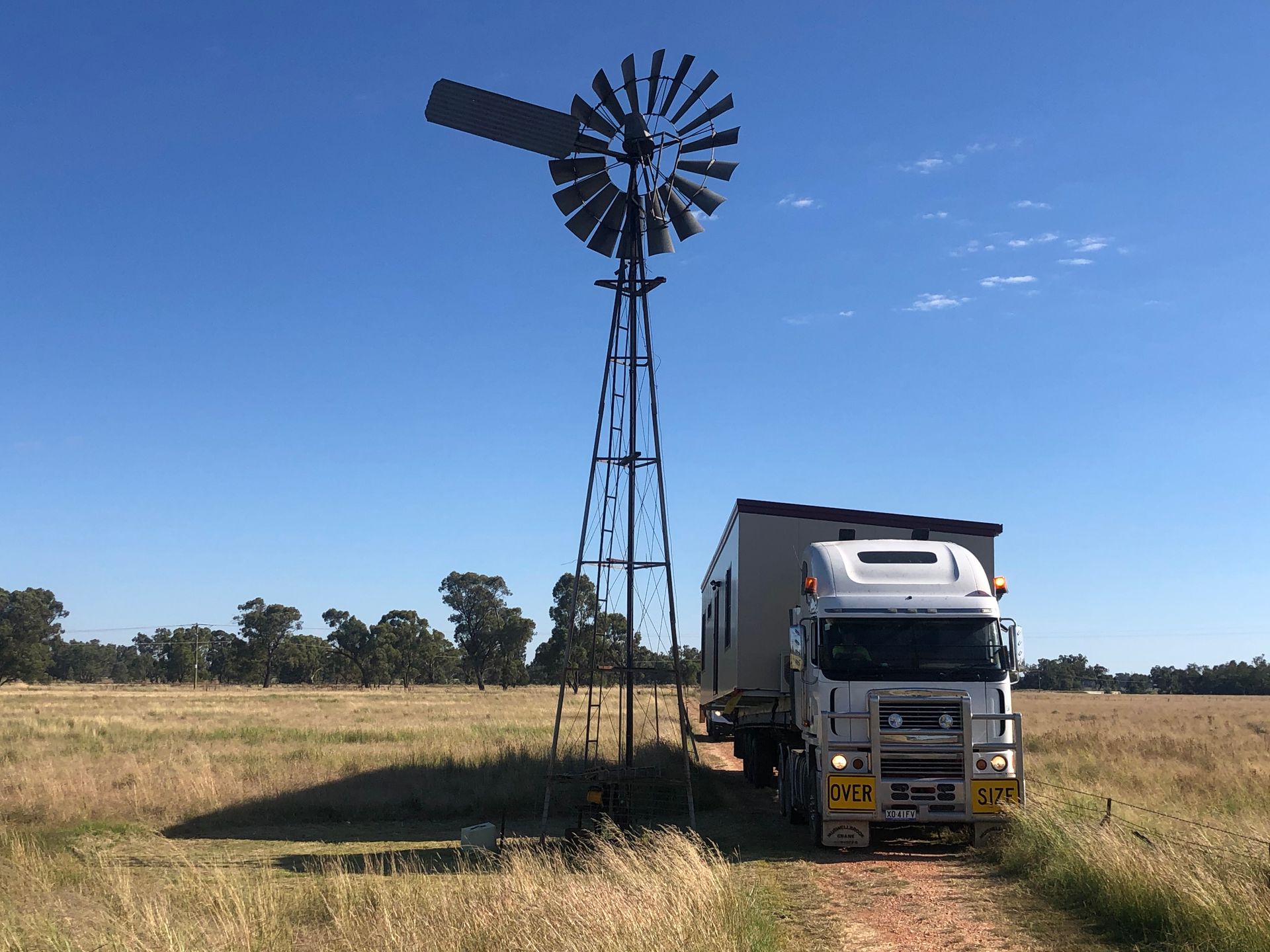 A Large White Semi-truck Pulls a Manufactured Home — OSM Transportables In Dubbo, NSW