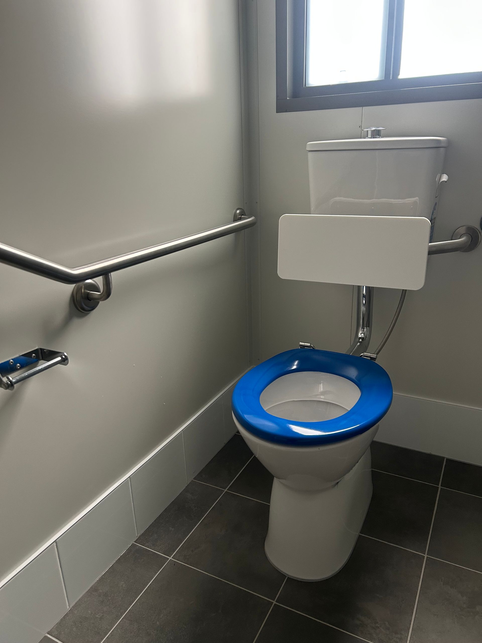Accessible Toilet With a Blue Seat, White Backrest — OSM Transportables In Dubbo, NSW
