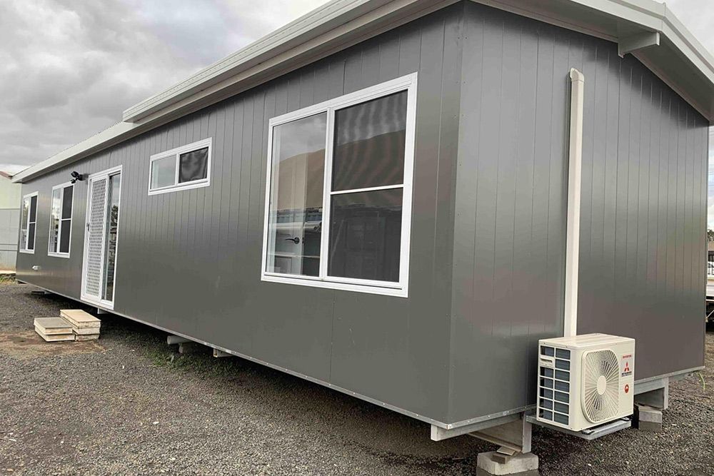 Dark Grey Portable House With Sliding Window Glass, Door and Aircon — OSM Transportables In Dubbo, NSW