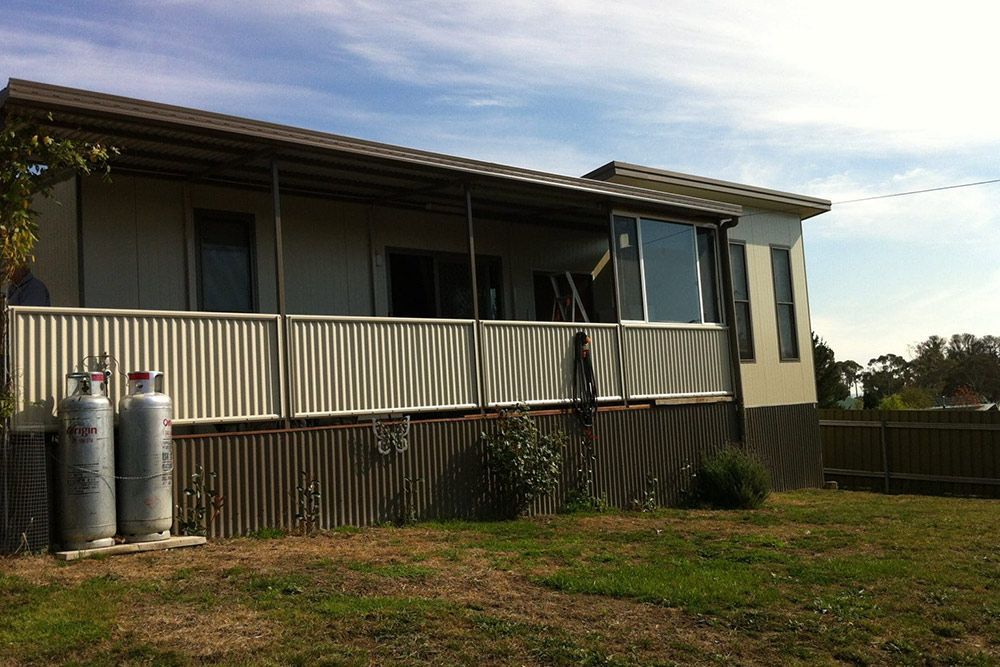 Portable House With Long Gas Tanks in the Yard — OSM Transportables In Dubbo, NSW