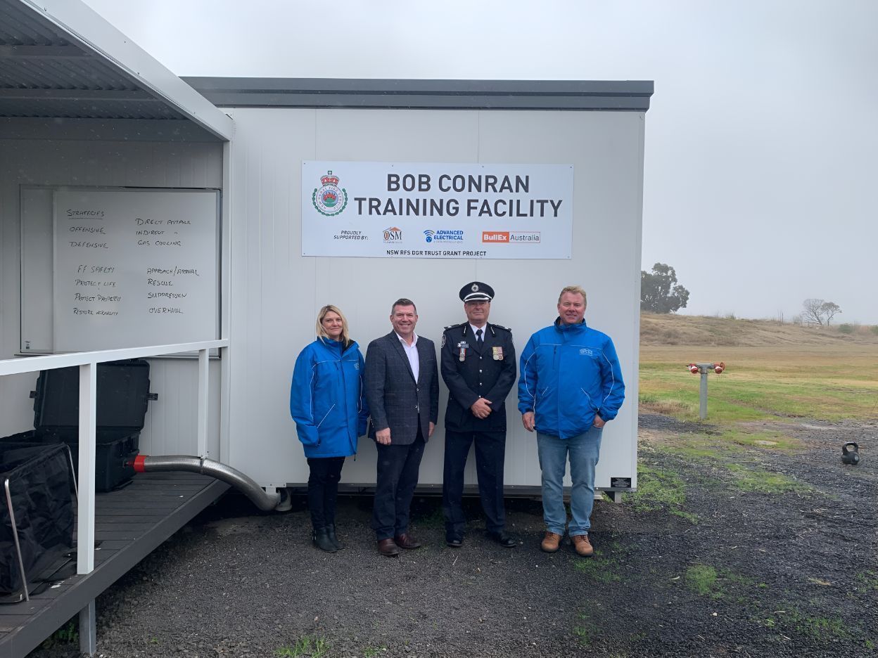 A Group of People Standing in Front of a Trailer That Says Bob Conran Training Facility — OSM Transportables In Dubbo, NSW