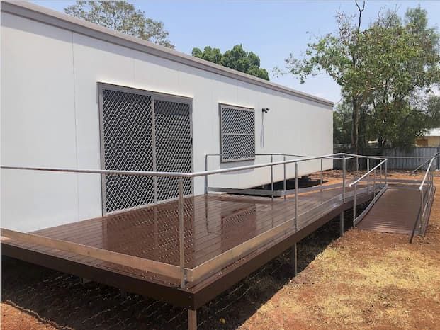 Side View of a Transportable House Featuring a Long, Dark Brown Staircase — OSM Transportables In Dubbo, NSW