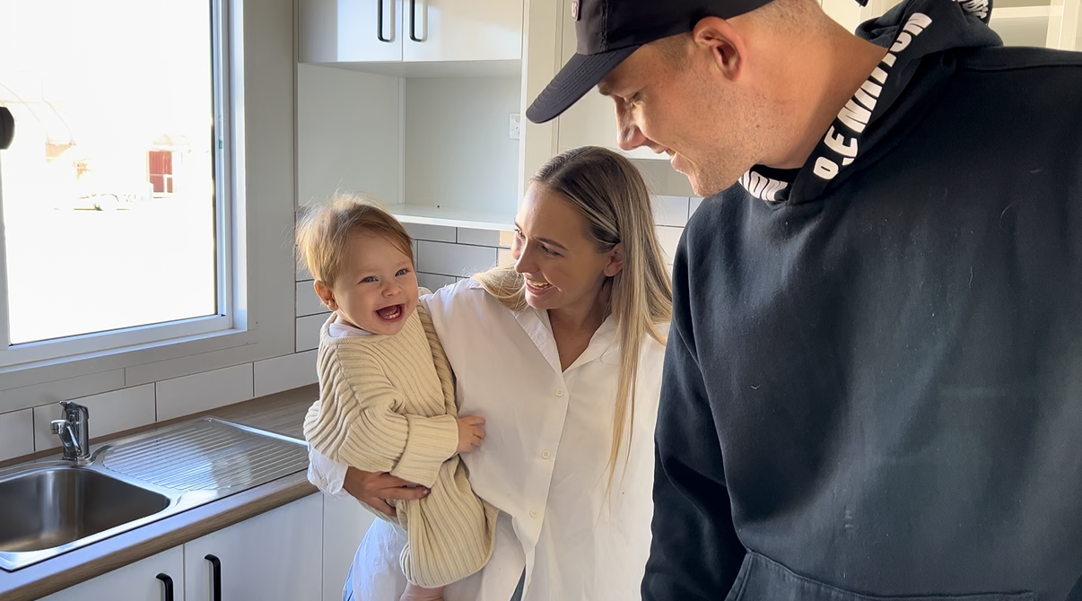 A Smiling Person Holding a Laughing Child in a Kitchen — OSM Transportables In Dubbo, NSW