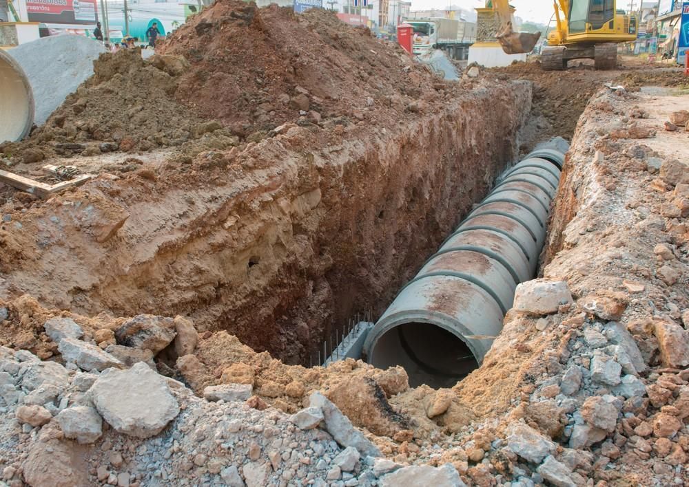 Trench With Concrete Pipes, Showing Construction Work on a Road — VR Marsden Plumbing in Red Rock, NSW