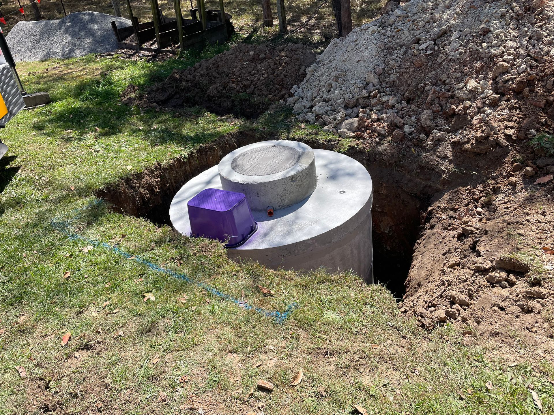 Concrete septic tank in a partially dug hole with dirt and gravel— VR Marsden Plumbing in Red Rock, NSW