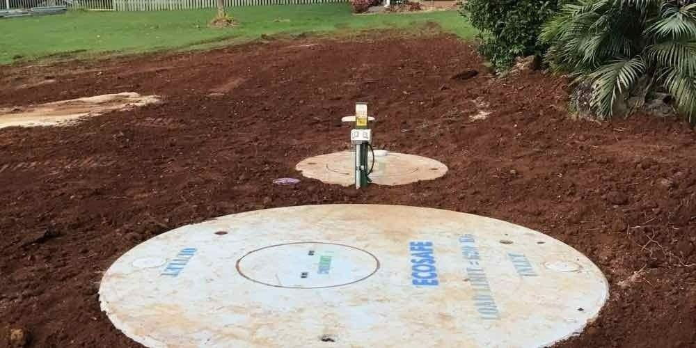 A Yard With a Freshly Turned Soil, With Concrete Covers of Septic Tanks — VR Marsden Plumbing in Red Rock, NSW