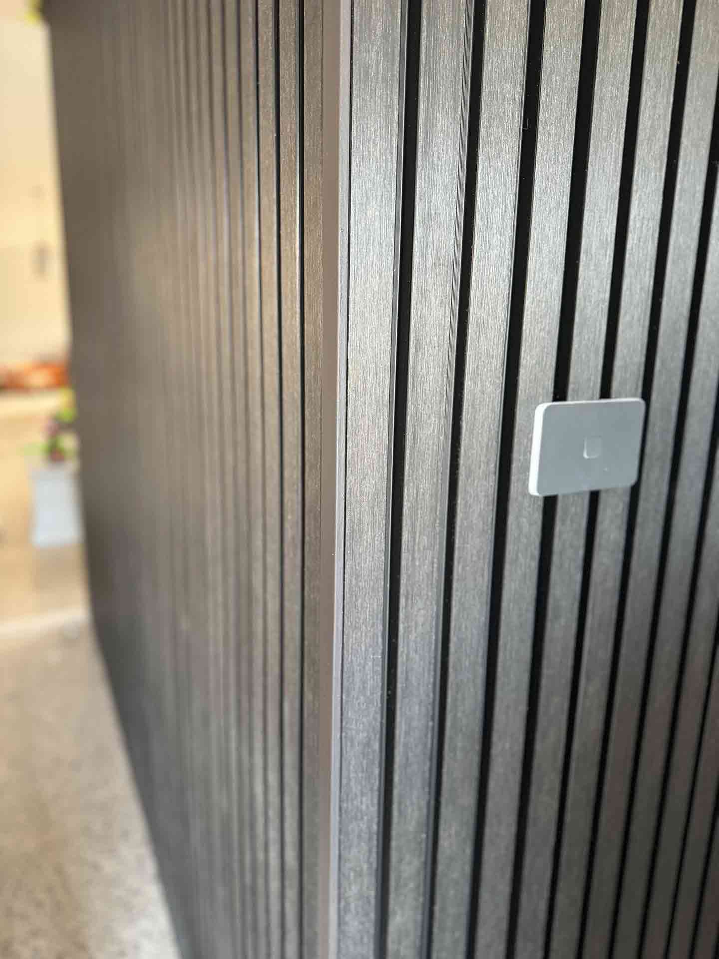 A Close Up of a Wooden Wall With a Light Switch on It — Hart Projects Wollongong In Shellharbour, NSW