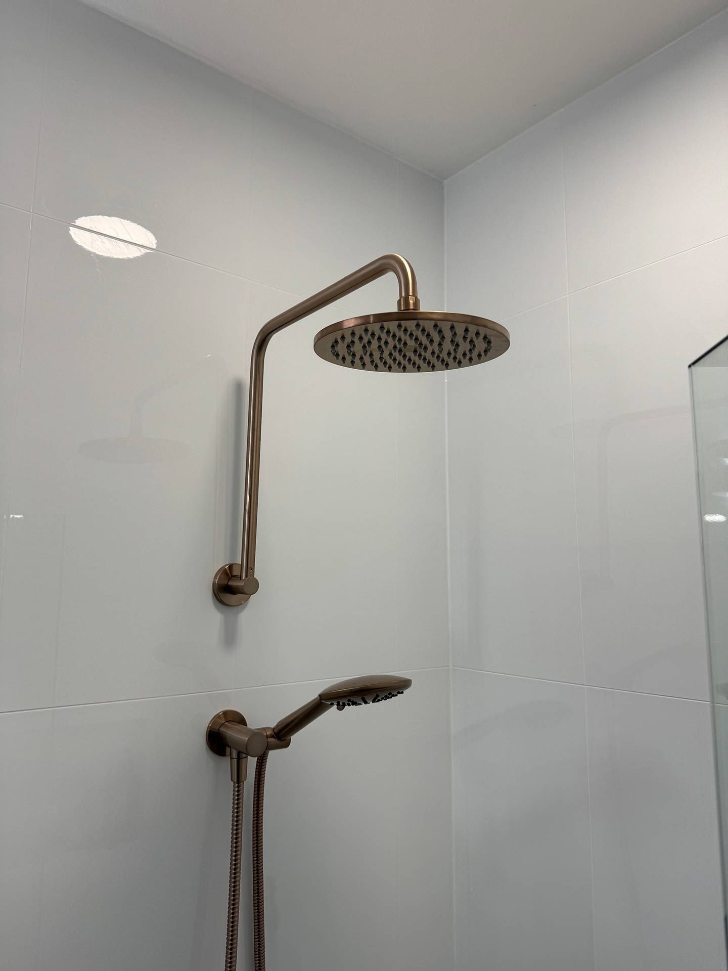 A Shower Head is Hanging From the Ceiling in a Bathroom — Hart Projects Wollongong In Kiama, NSW