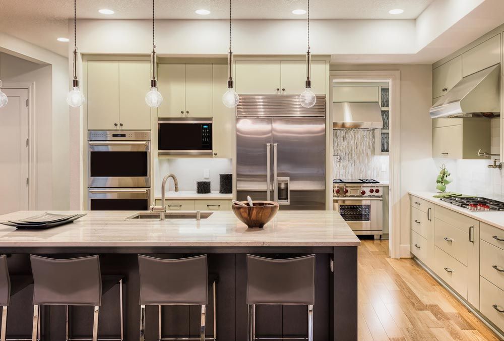 A Kitchen With Stainless Steel Appliances and a Large Island — Hart Projects Wollongong In Dapto, NSW
