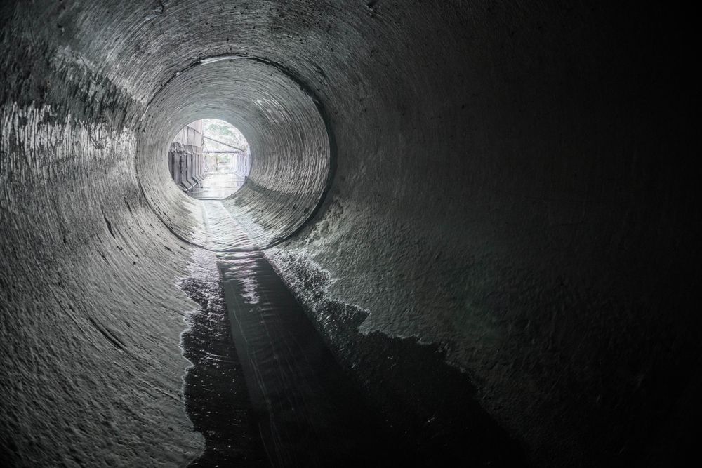 Inside a Dark Concrete Pipe — Shreks Septic Services in Gowrie Junction, QLD