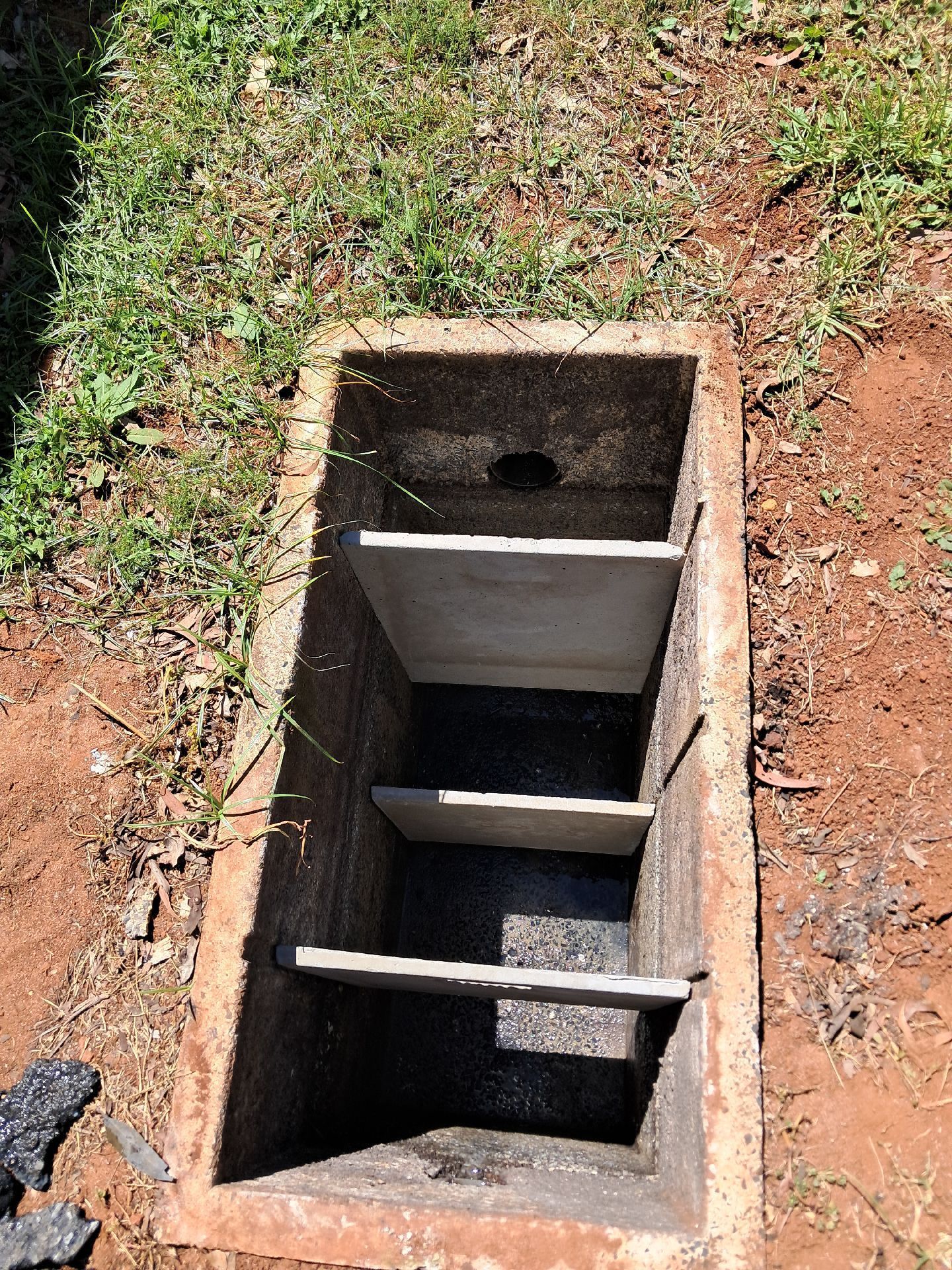 Open Rectangular Concrete Utility Pit in Dirt — Shreks Septic Services in Gowrie Junction, QLD