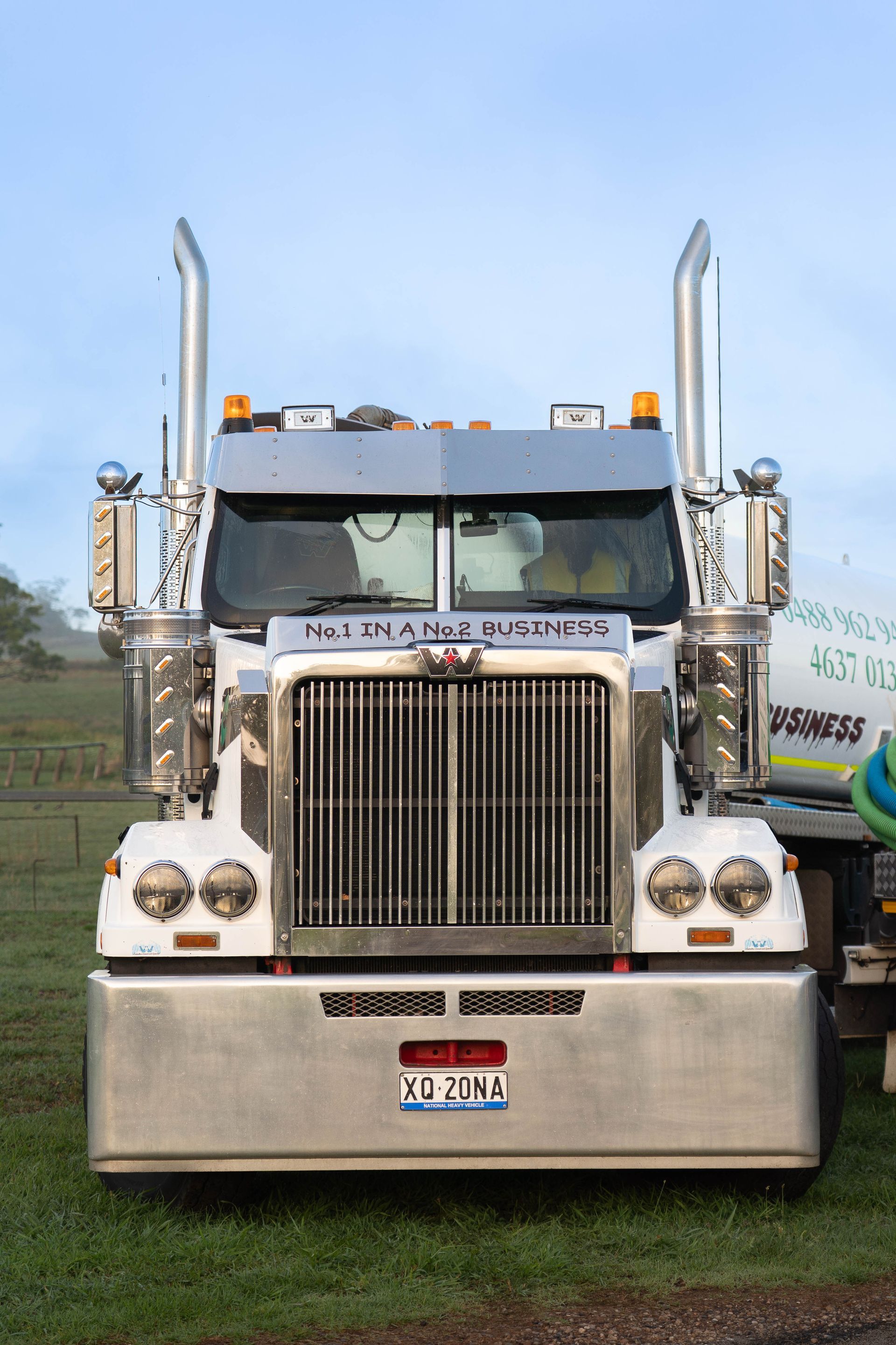Front View of a Silver Semi-truck Parked on Grass — Shreks Septic Services in Gowrie Junction, QLD