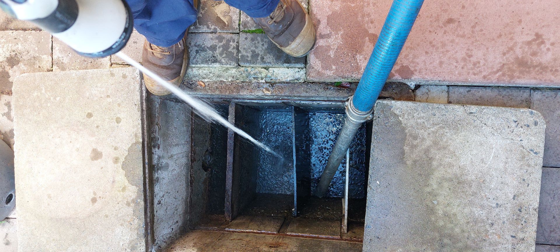 Water Being Sprayed Into a Concrete Drainage Pit — Shreks Septic Services in Cambooya, QLD