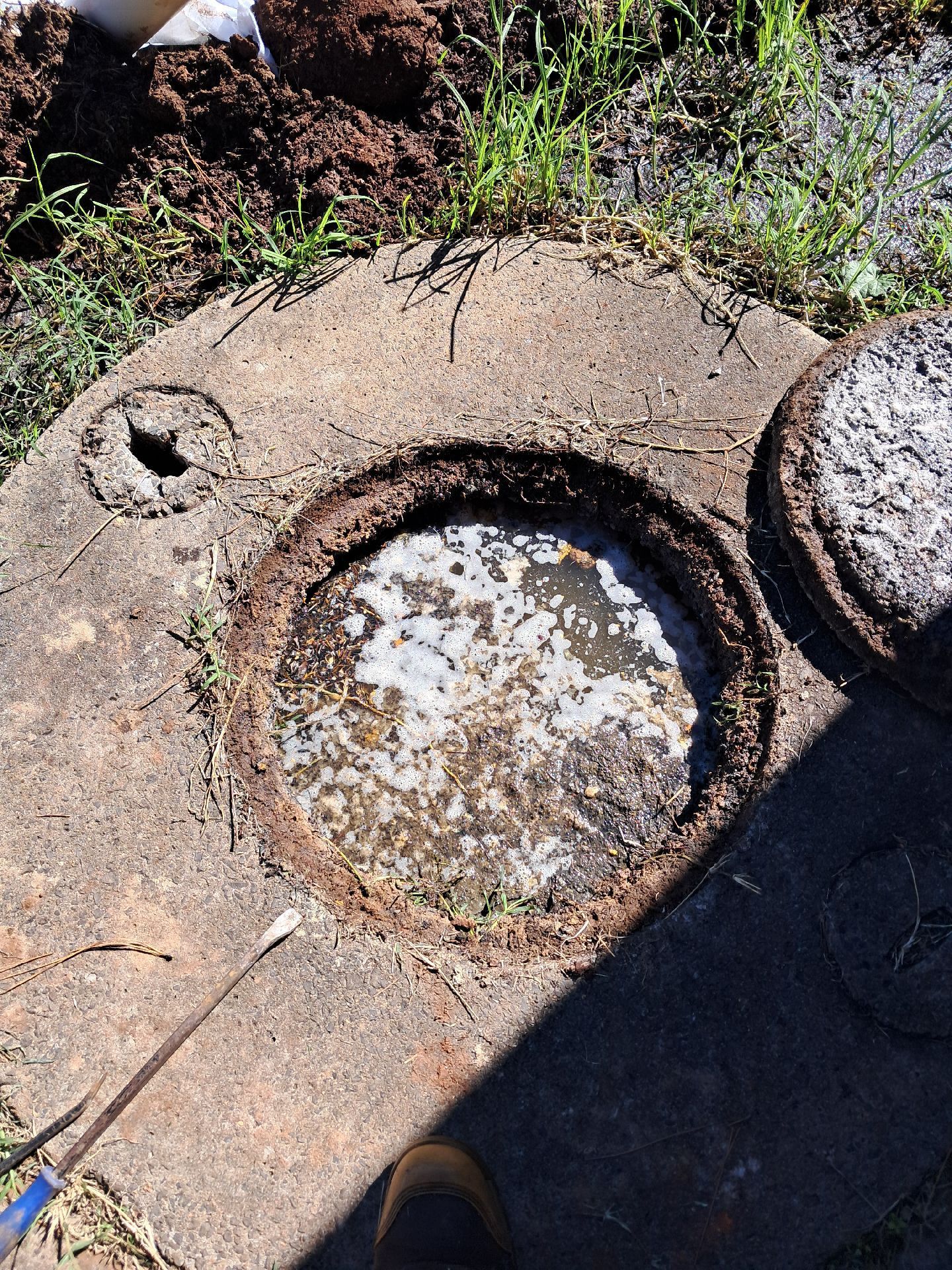 Close-up of a Weathered Concrete Hole Filled — Shreks Septic Services in Crows Nest, QLD