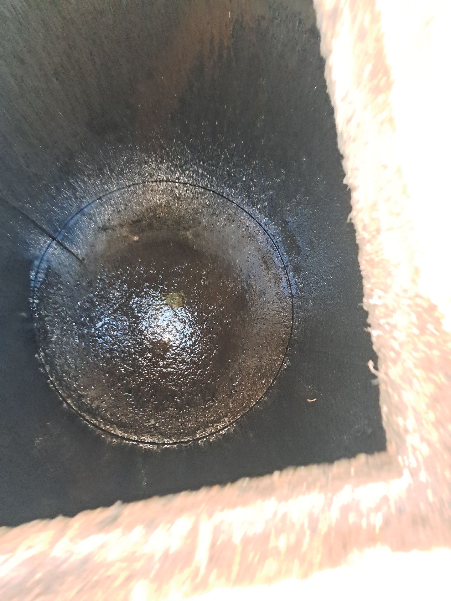Close-up of a Dark, Empty Cylindrical Container — Shreks Septic Services in Dalby, QLD