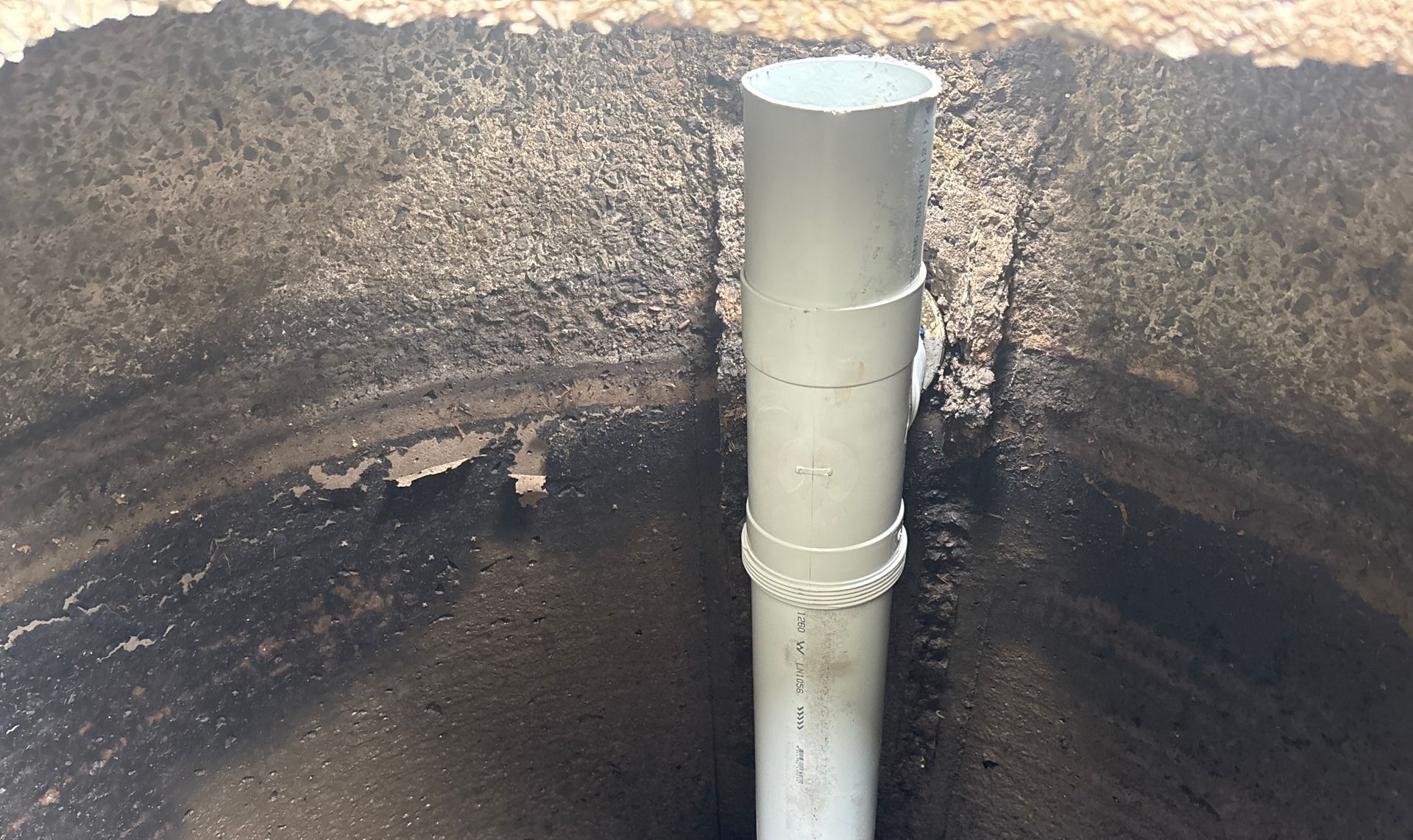 Gray Pvc Pipe Rising From a Dark Soil Pit — Shreks Septic Services in Oakey, QLD