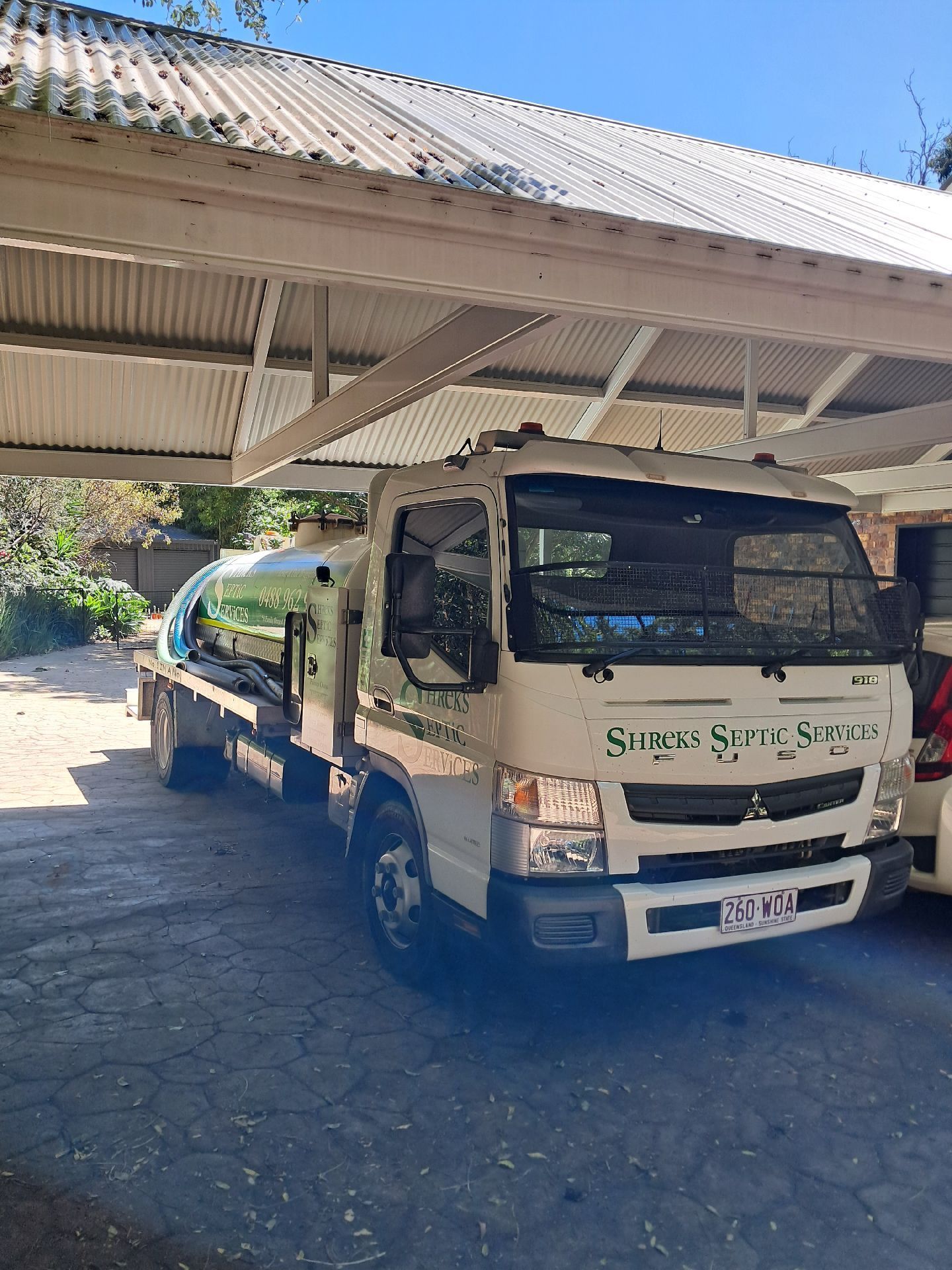 White Cargo Truck Parked Under a Metal Carport — Shreks Septic Services in Cambooya, QLD