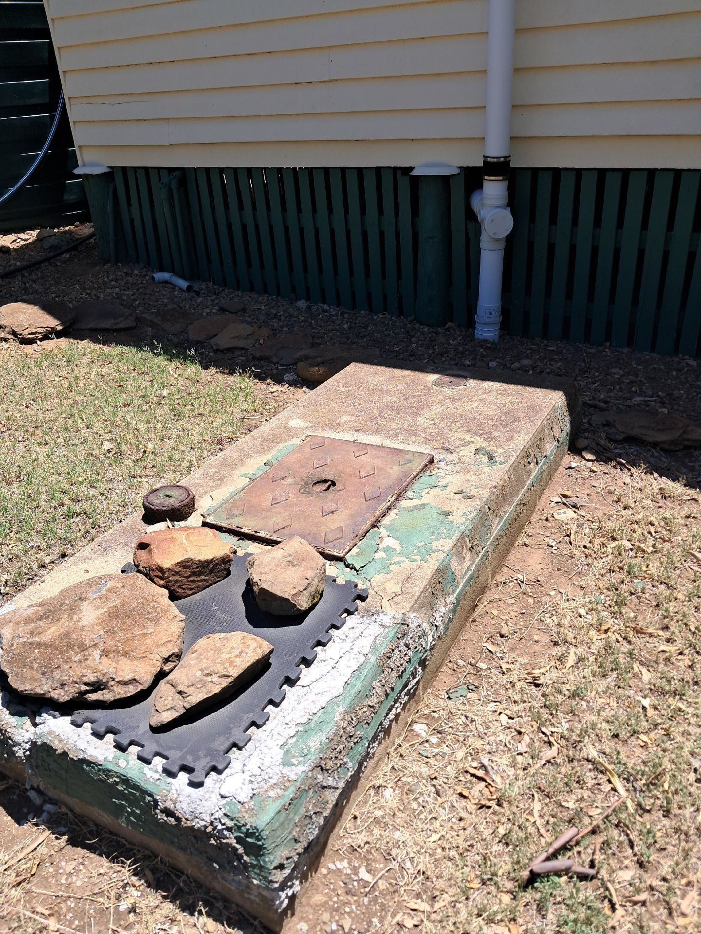 Backyard Utility Box With Rocks — Shreks Septic Services in Helidon, QLD