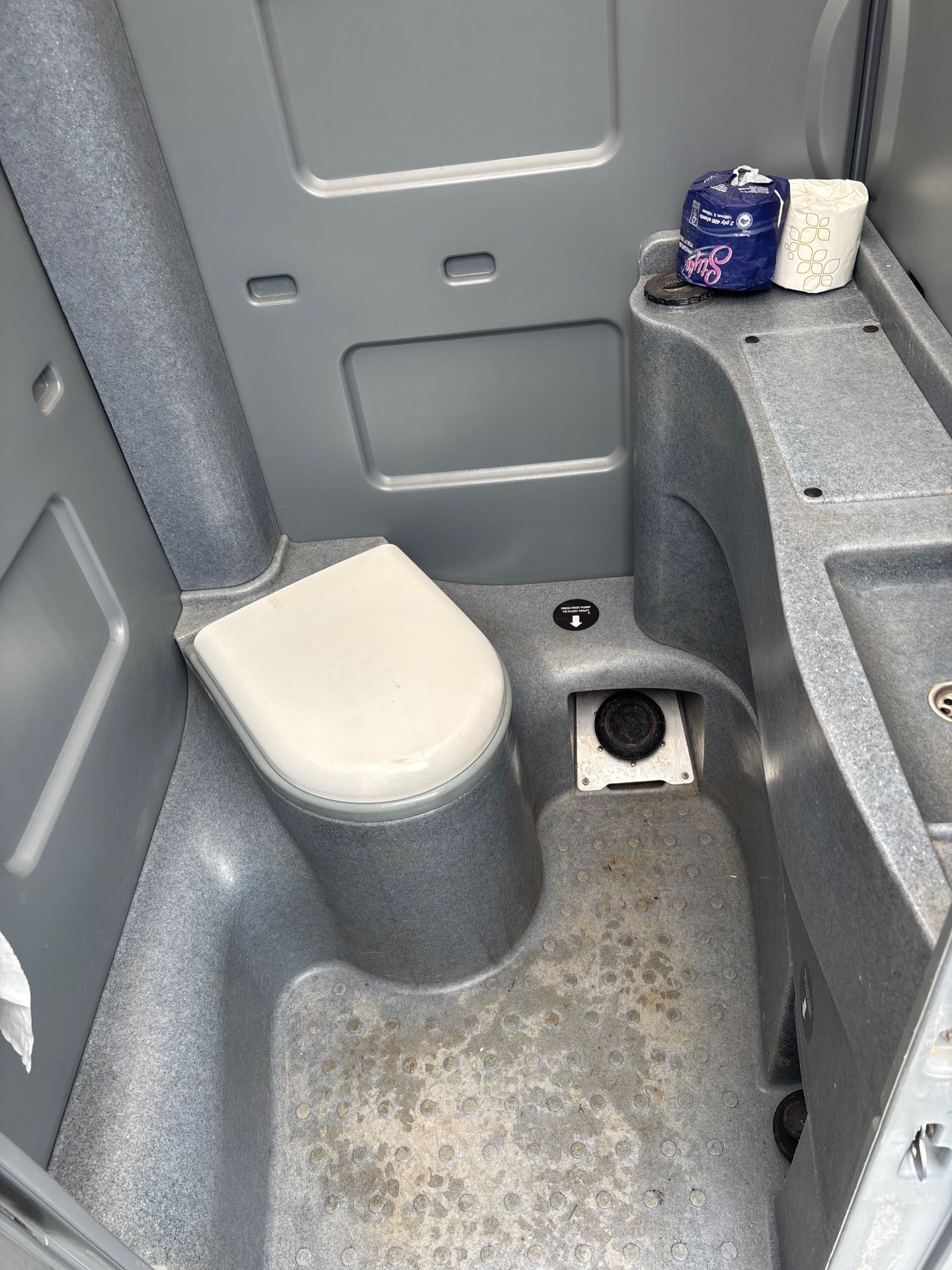 Interior of a Portable Toilet With Gray Walls — Shreks Septic Services in Oakey, QLD