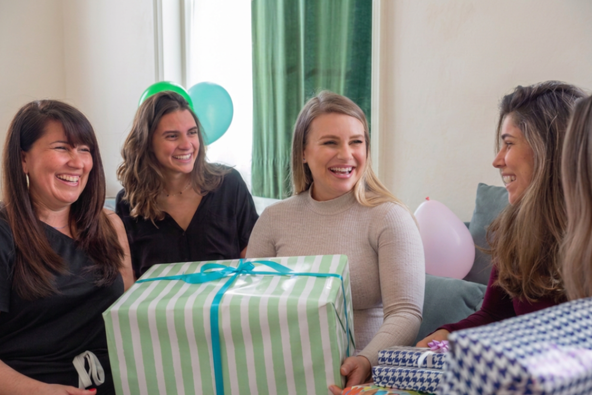group of family and friends giving presents to expectant mom