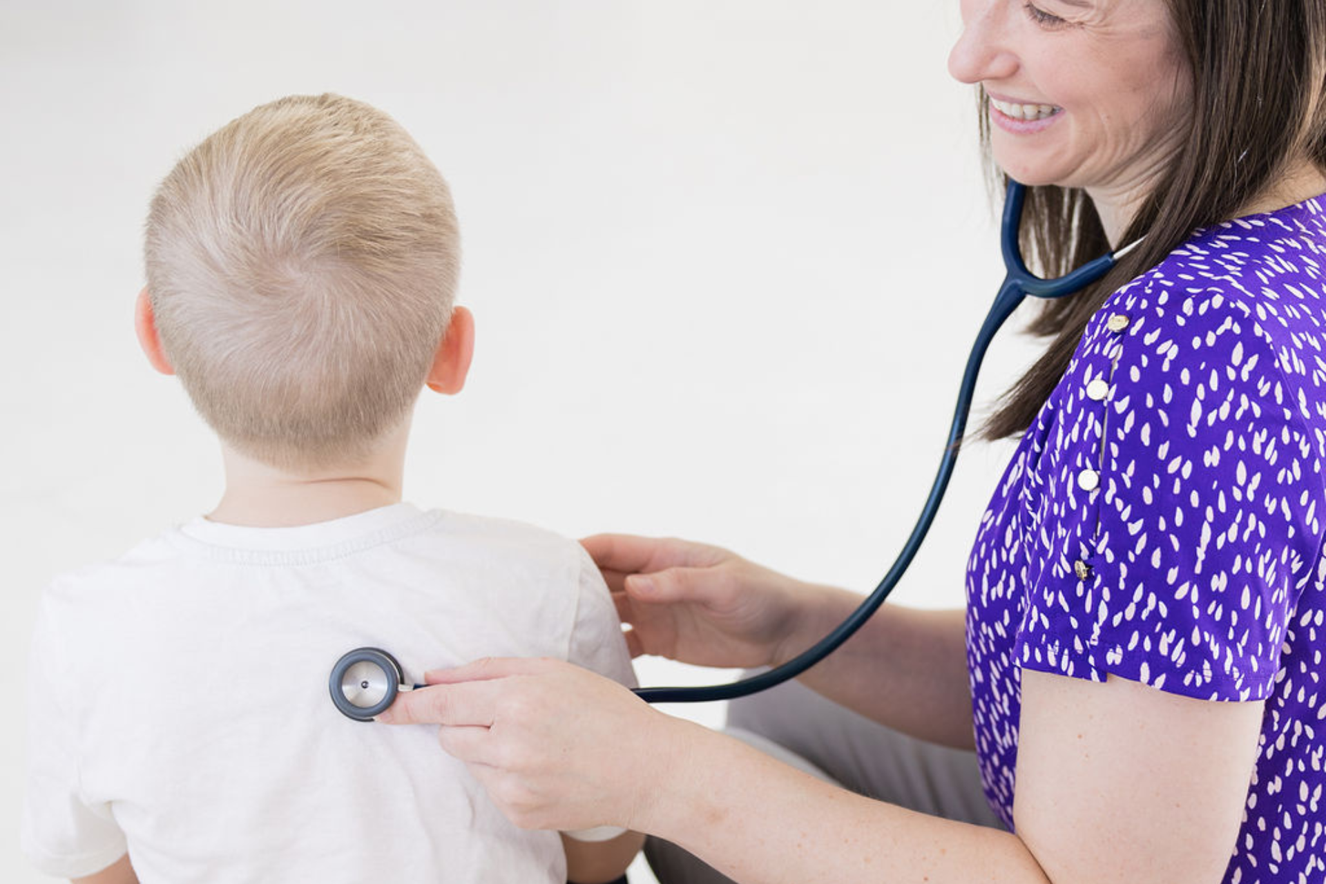 pediatrician examining child with stethoscope